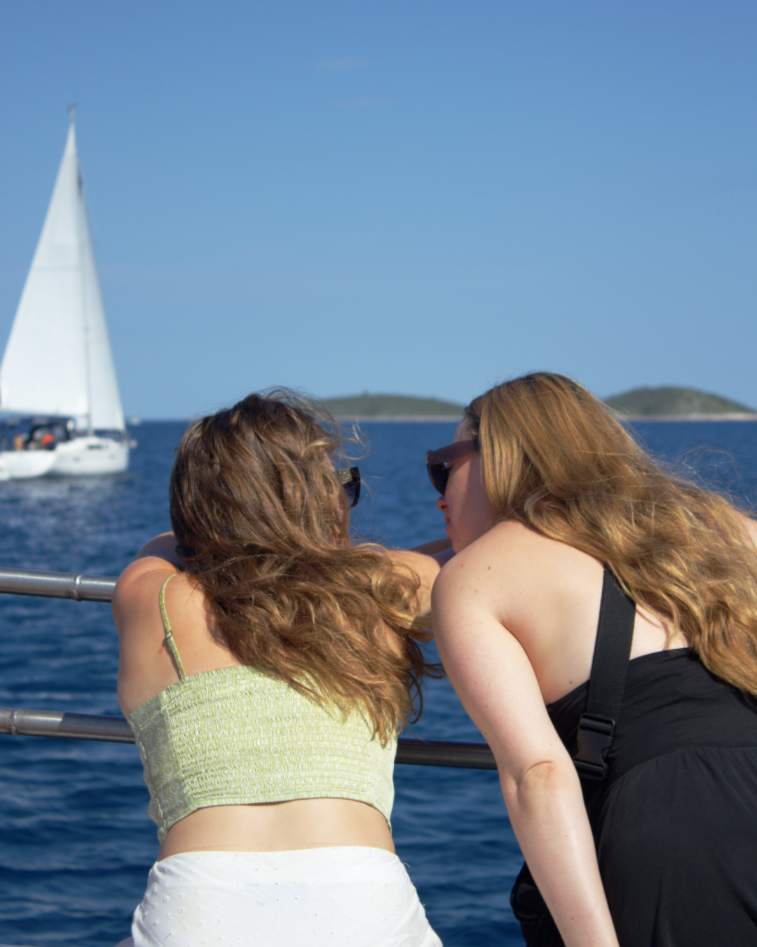 Scenic sea view with sailboats passing by as guests unwind on Flipper One tour of Croatian islands.