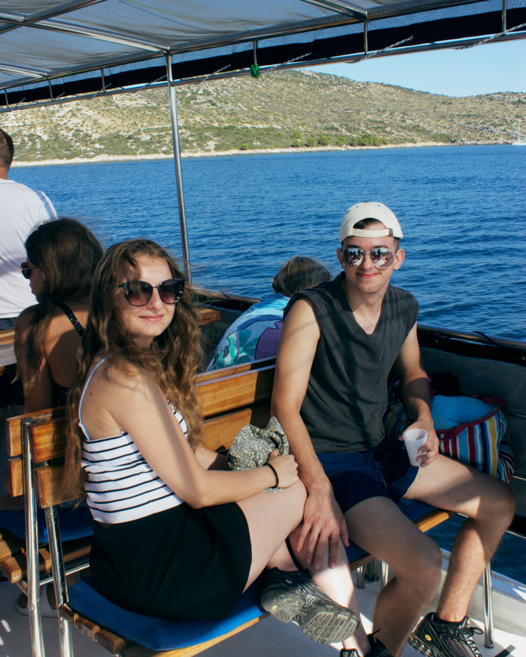 Young couple sitting peacefully on board Flipper One while cruising near Telašćica and Kornati islands.