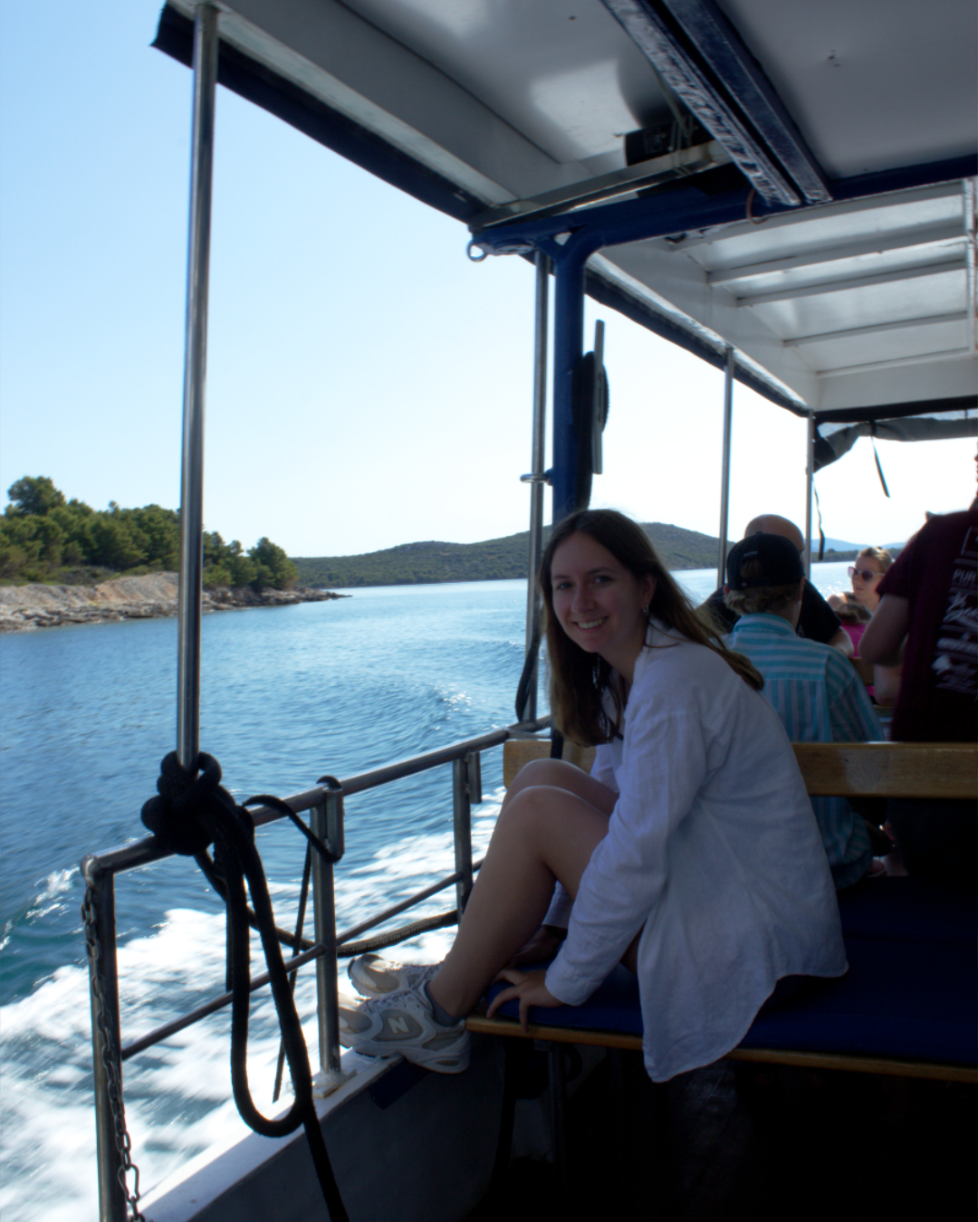 Peaceful boat ride moment — young traveler enjoying the Adriatic coastline near Telašćica cliffs.