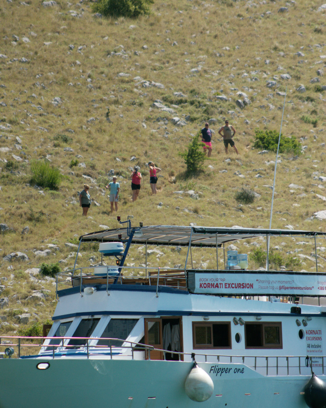 Guests exploring island landscapes after docking — a typical land stop during Kornati tour.