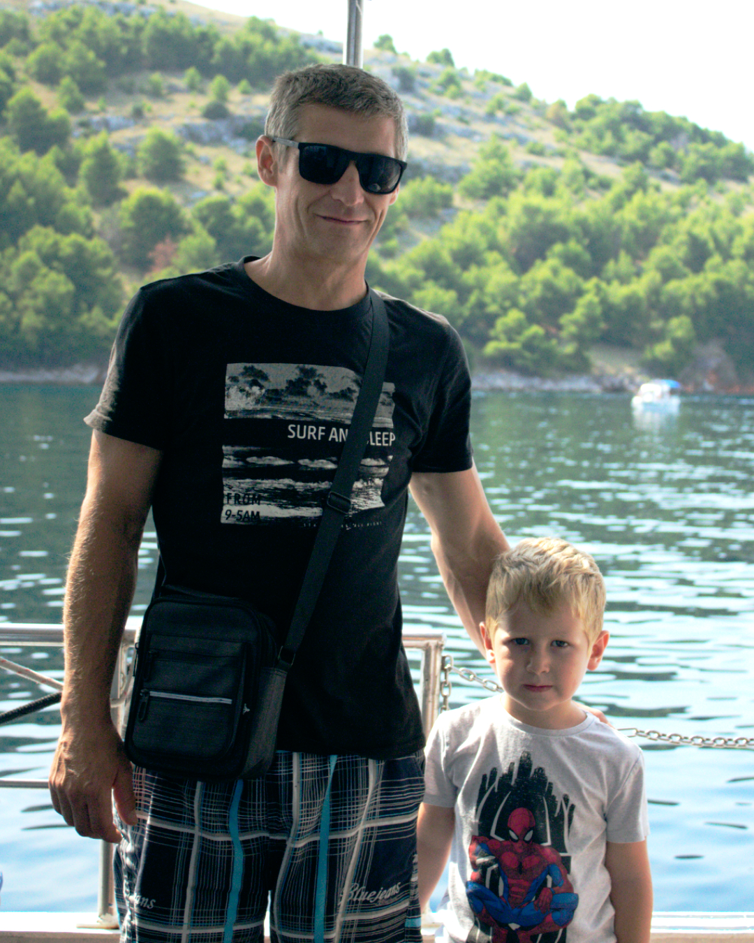 Father and son enjoying the view from the dock before boarding Flipper One boat trip in Croatia.