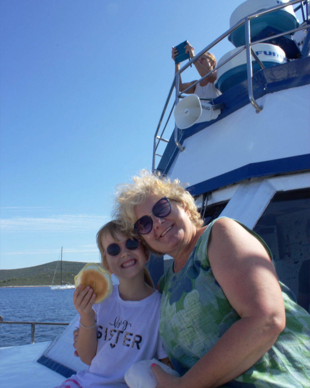 Generations enjoying a fun snack and warm sunshine on board Flipper One boat in Croatia.