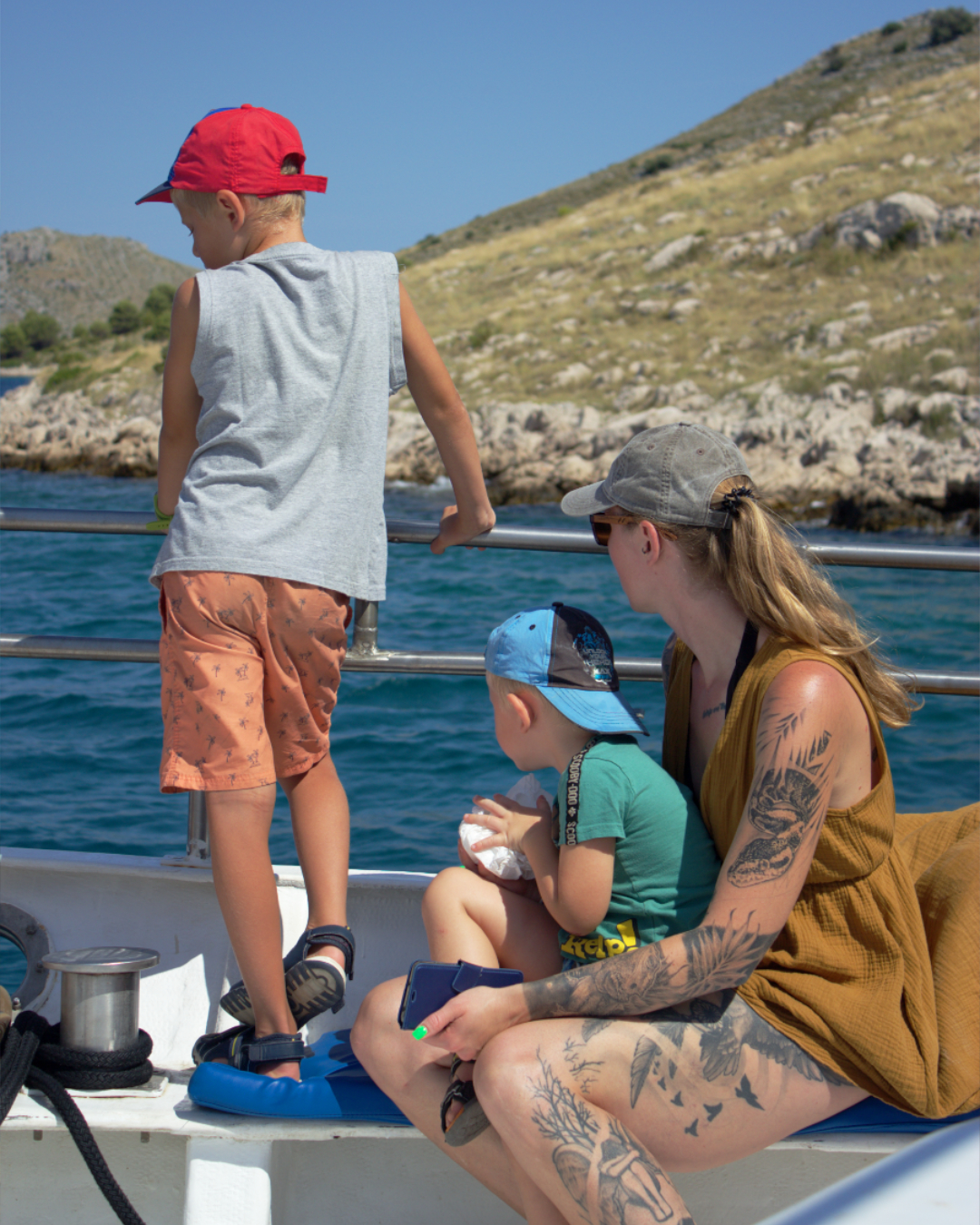Parents and children watching waves roll by during a boat trip stop at Telašćica Nature Park.