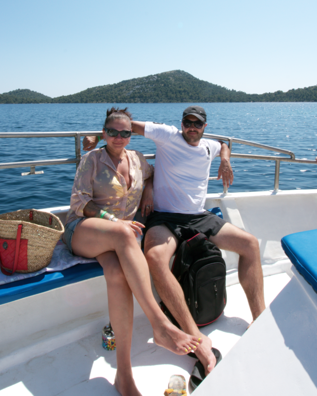 Relaxed couple soaking up the sun and Adriatic views on the Flipper One boat tour in Croatia.